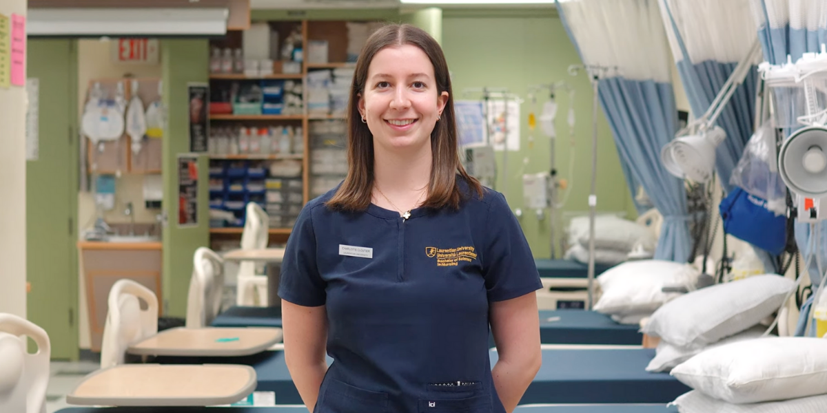 Charlotte Cloutier, a Laurentian University nursing student, smiling in a nursing simulation room.