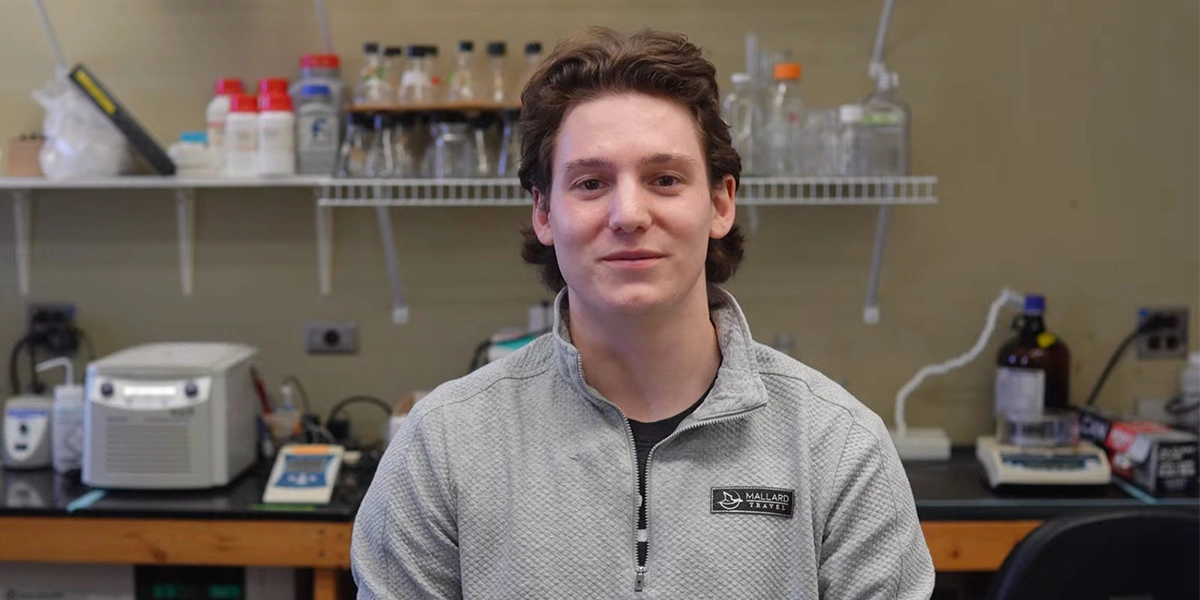 Owen Allard stands in a lab smiling