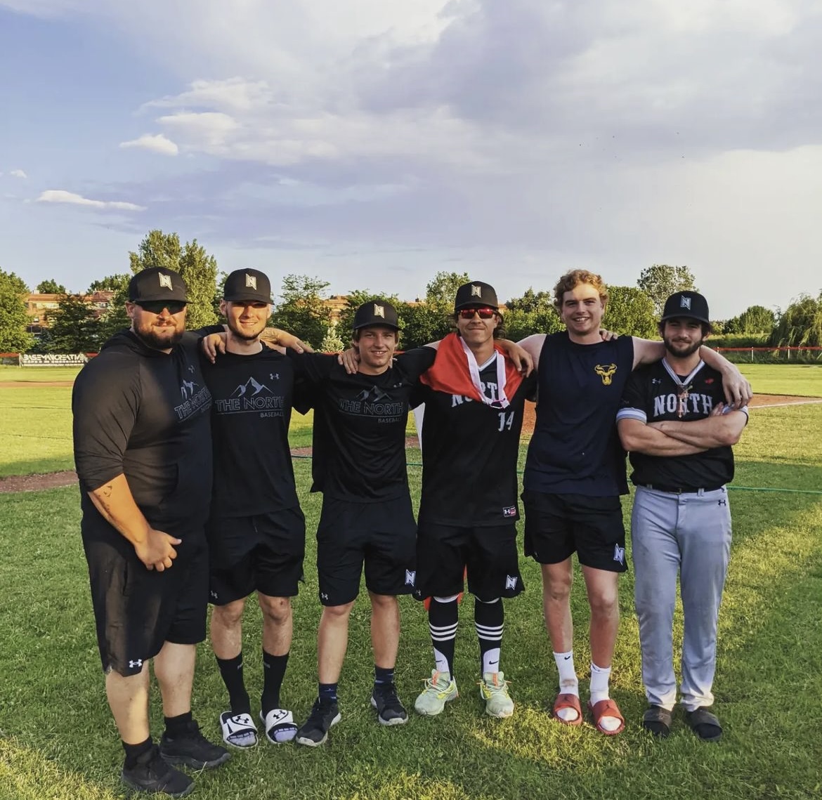 (From left to right), Kirby Smith, Ethan Berube, Andrew Weber, Matt Obradovich, Callum and Liam Socransky with their arms around each other. 