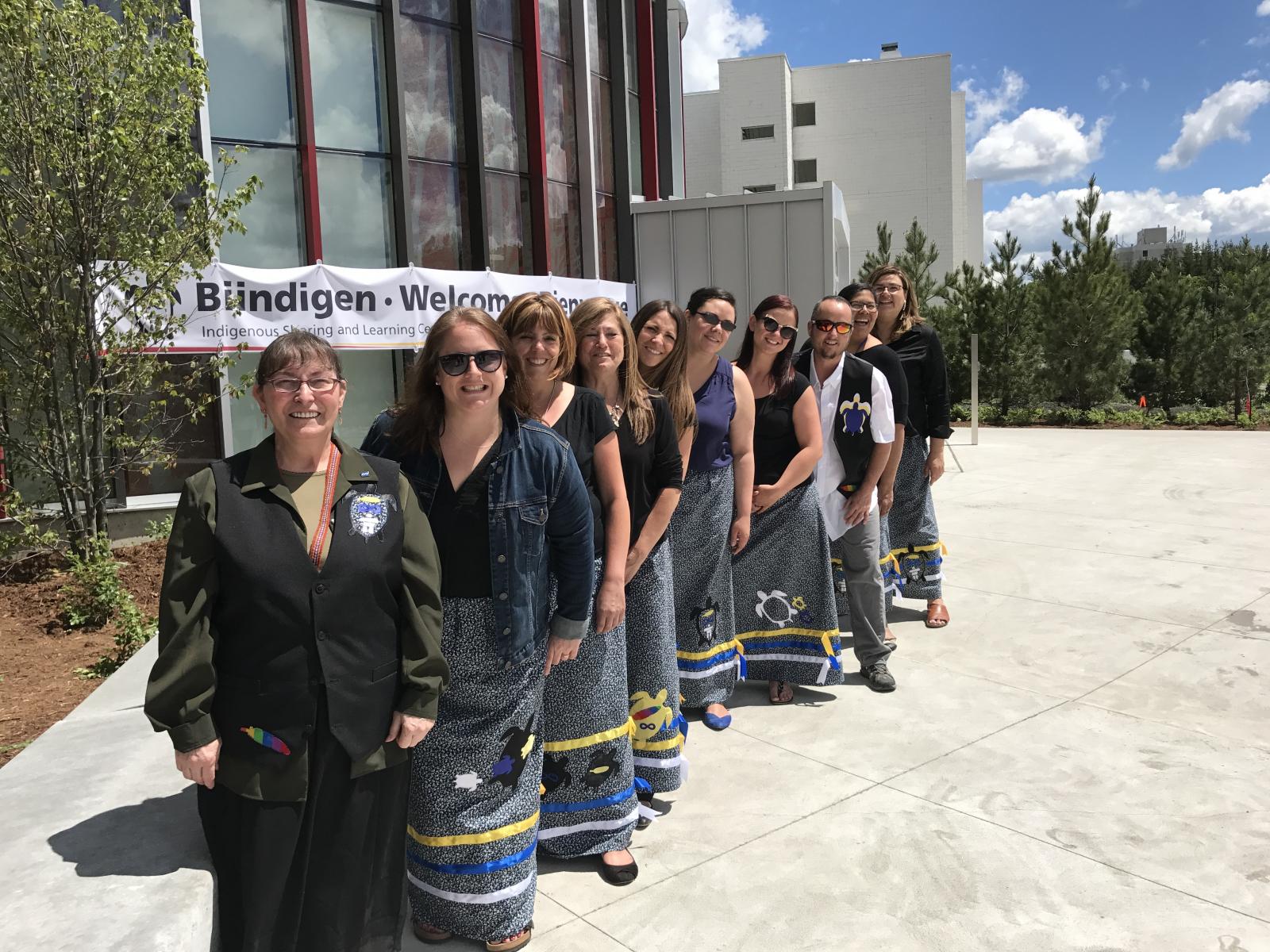 Indigenous Student Affairs Team standing in a line while outside 