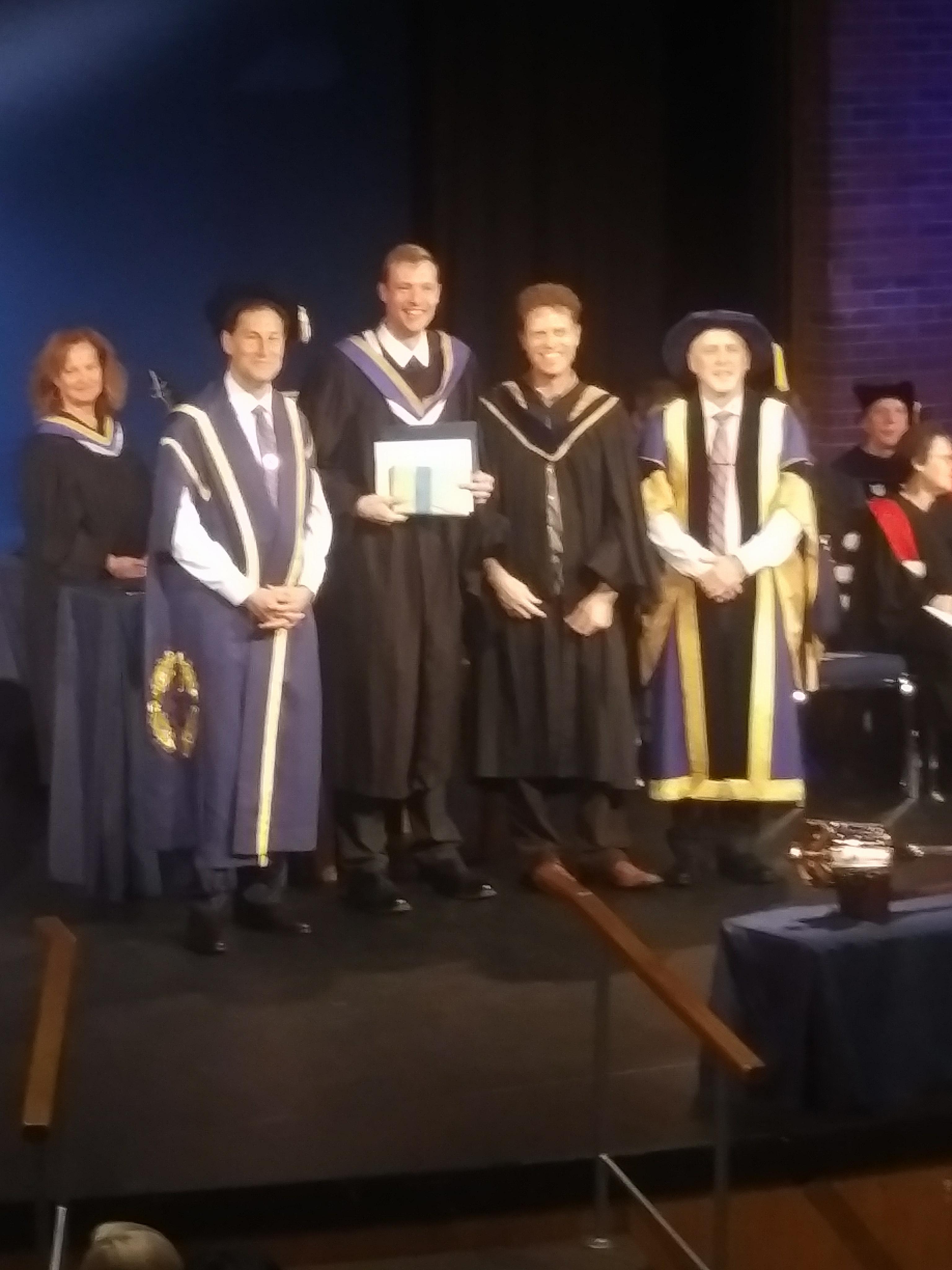 Student getting a diploma at convocation