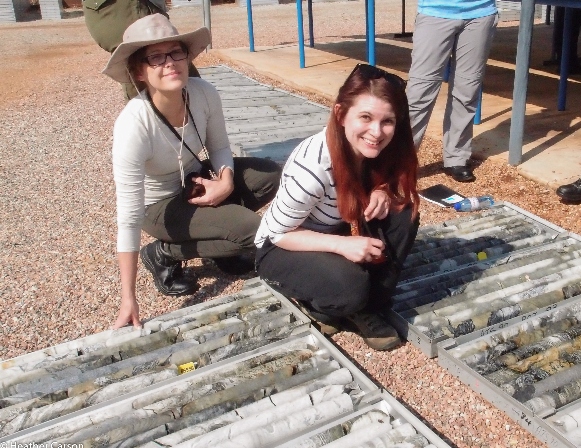 Two people crouching by sediment cores