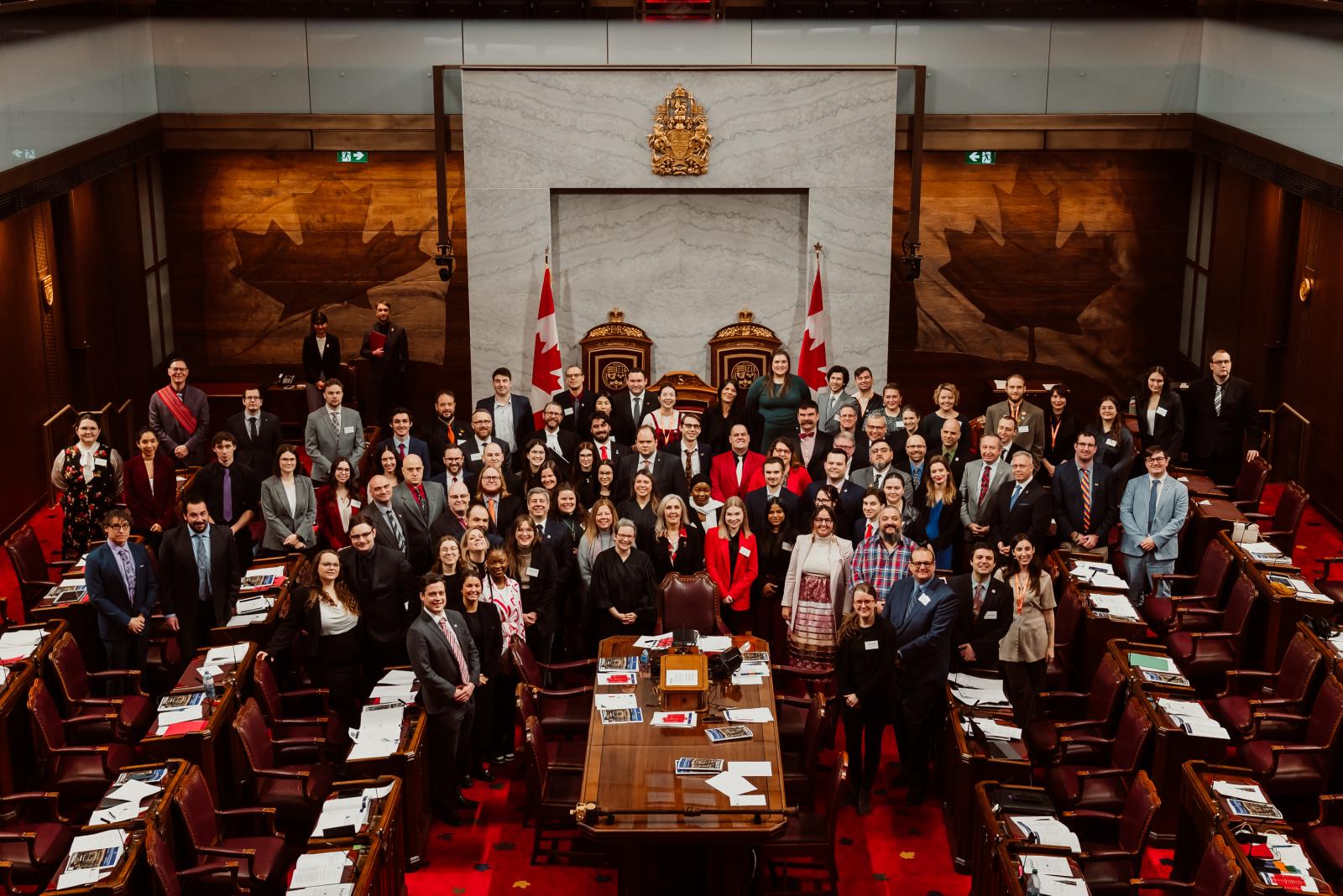 Model Parliament attendees pose for a group photo in the Senate Chamber 