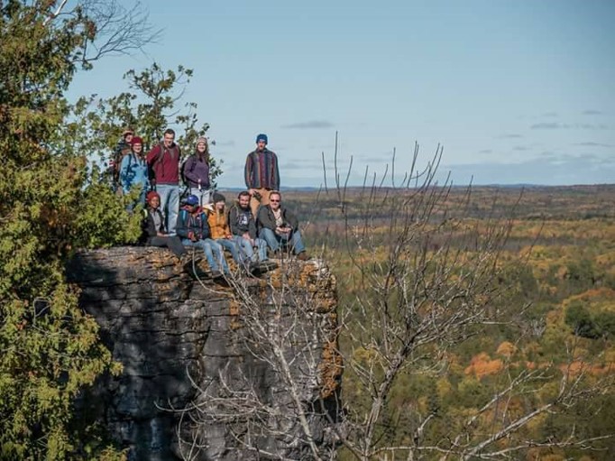 A group of people on an elevated rock