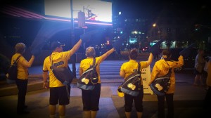  Team leaders standing on the side of the road while wearing yellow shirts