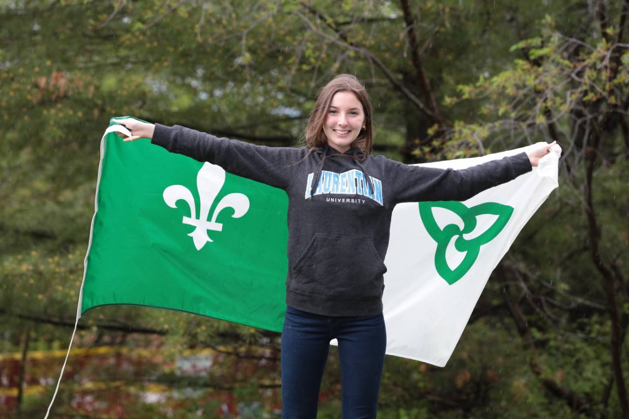 A laurentian student holding the Franco-Ontarian flag i
