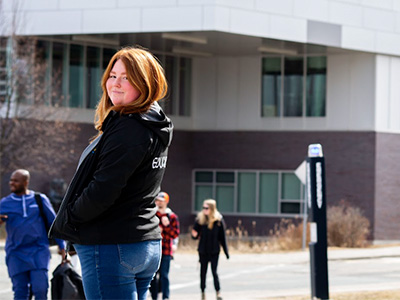 Emily Henry proudly stands in front of the Education Building on Laurentian’s campus where she took many classes and built lasting relationships with peers and professors.