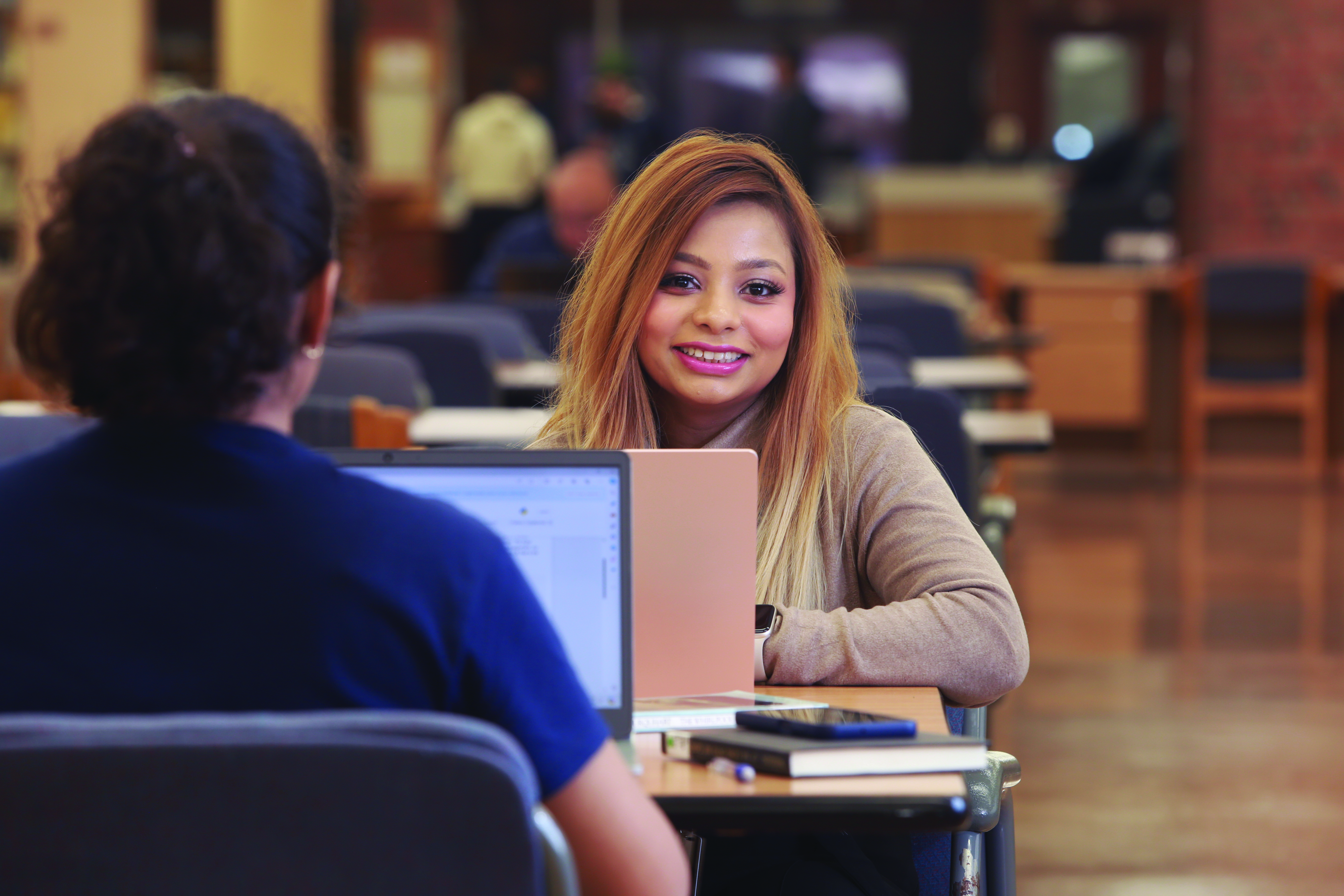 A Laurentian University student on her laptop in the J.N. Desmarais library.