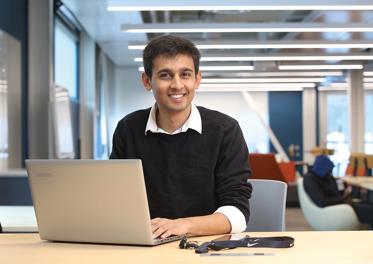 Student sitting at desk with laptop