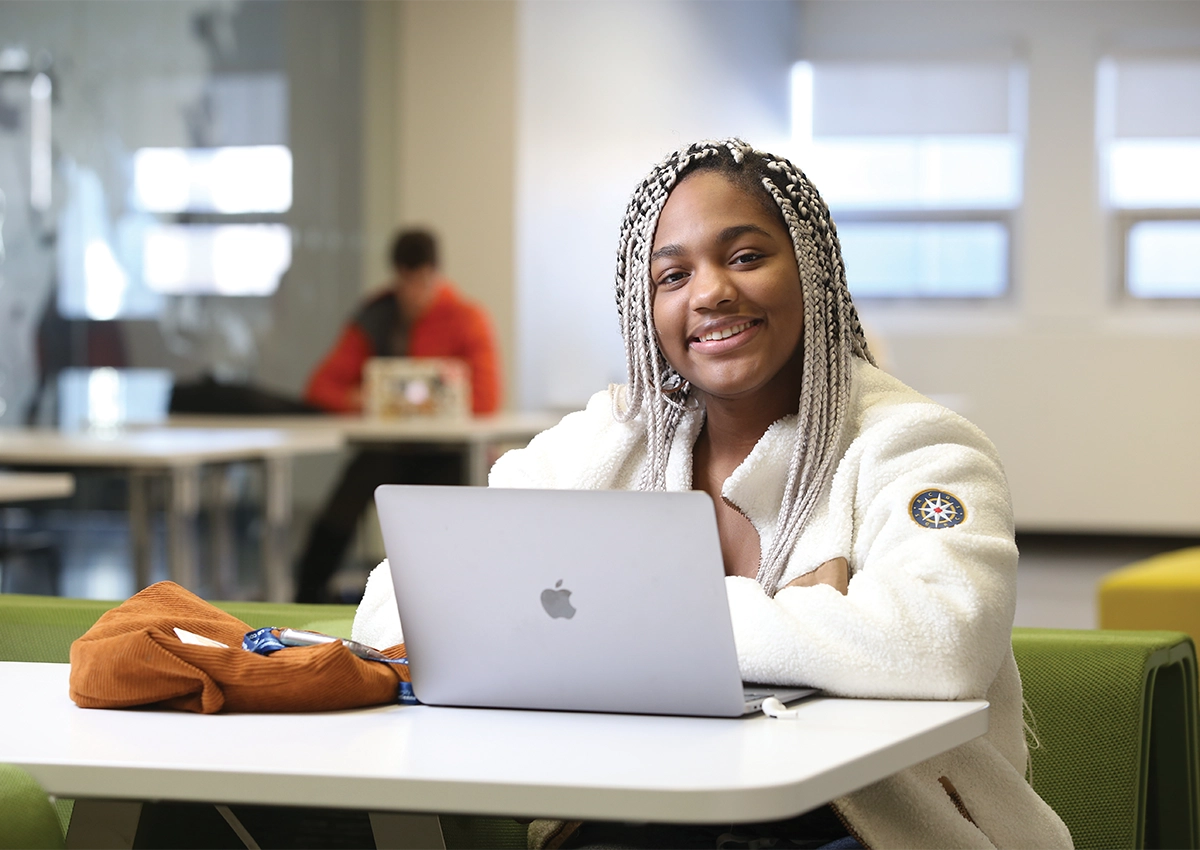 Person sitting at desk with laptop