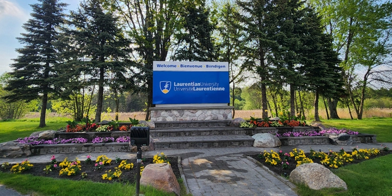 The Laurentian University sign and garden at the campus entrance.