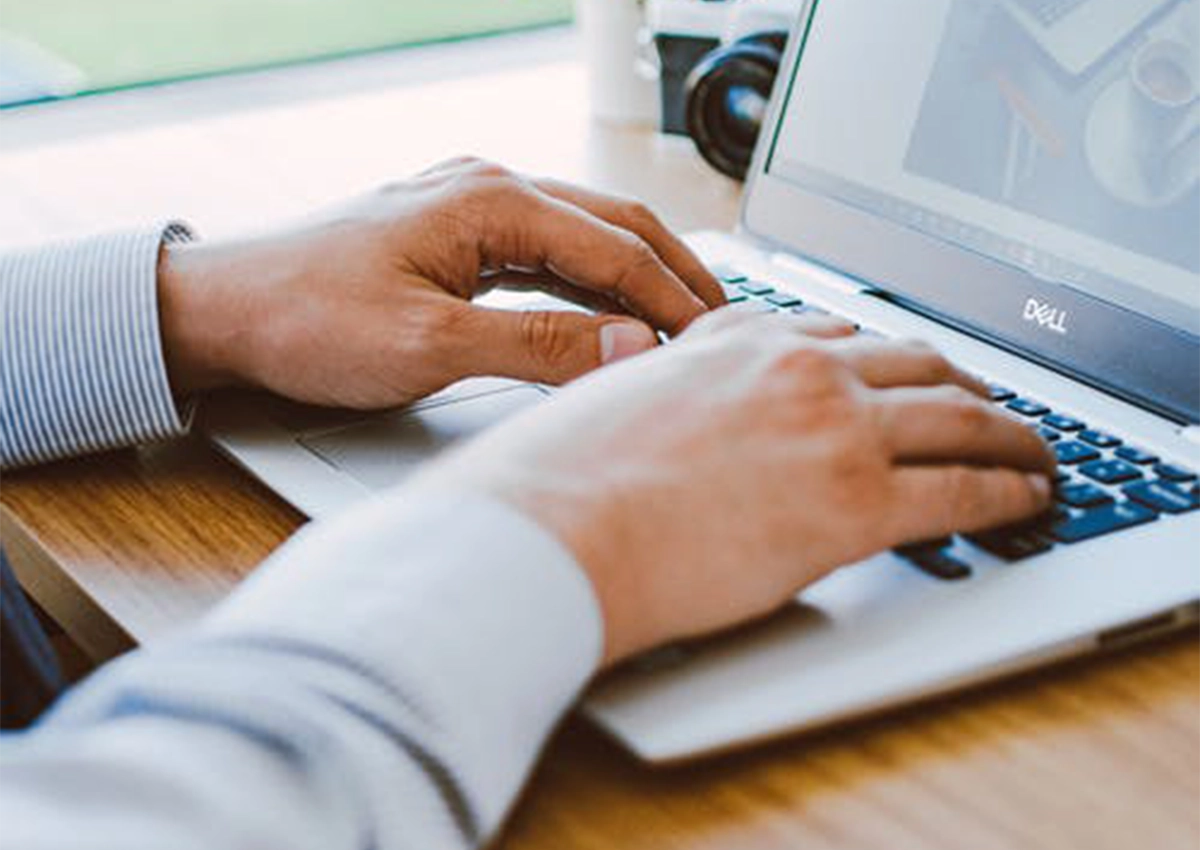 person typing on laptop