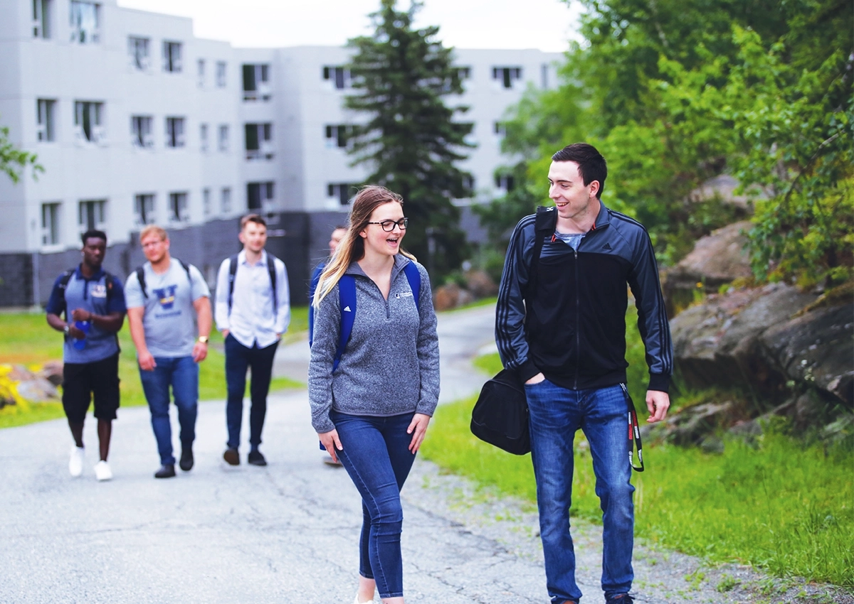 Laurentian University students walking towards campus from Single Student Residence.