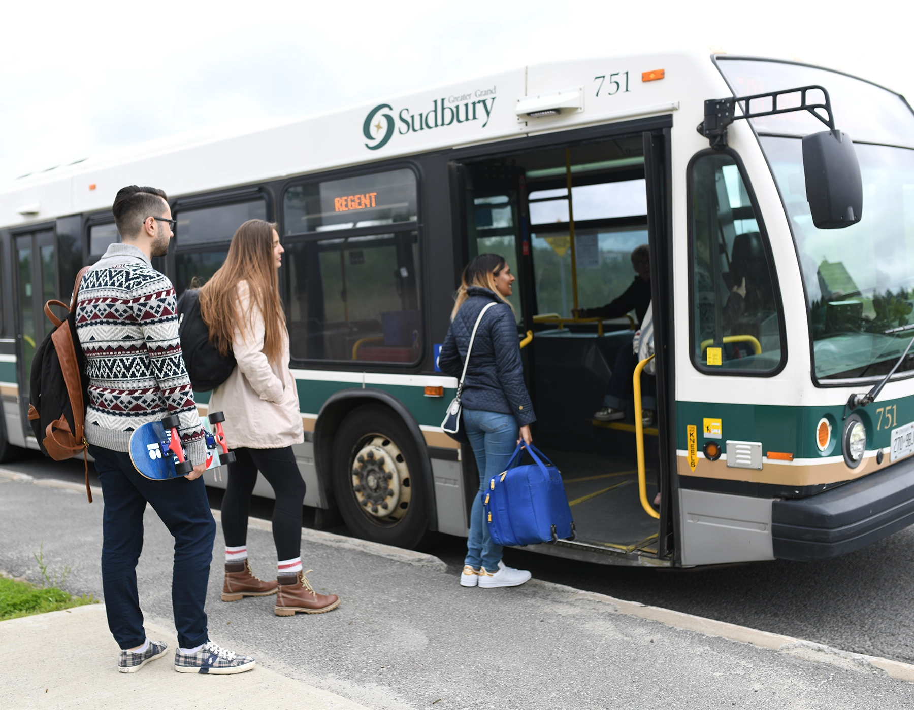 Students getting on a sudbury city bus