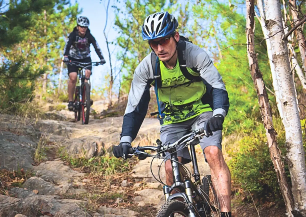 Two Laurentian University students mountain biking on the trails.