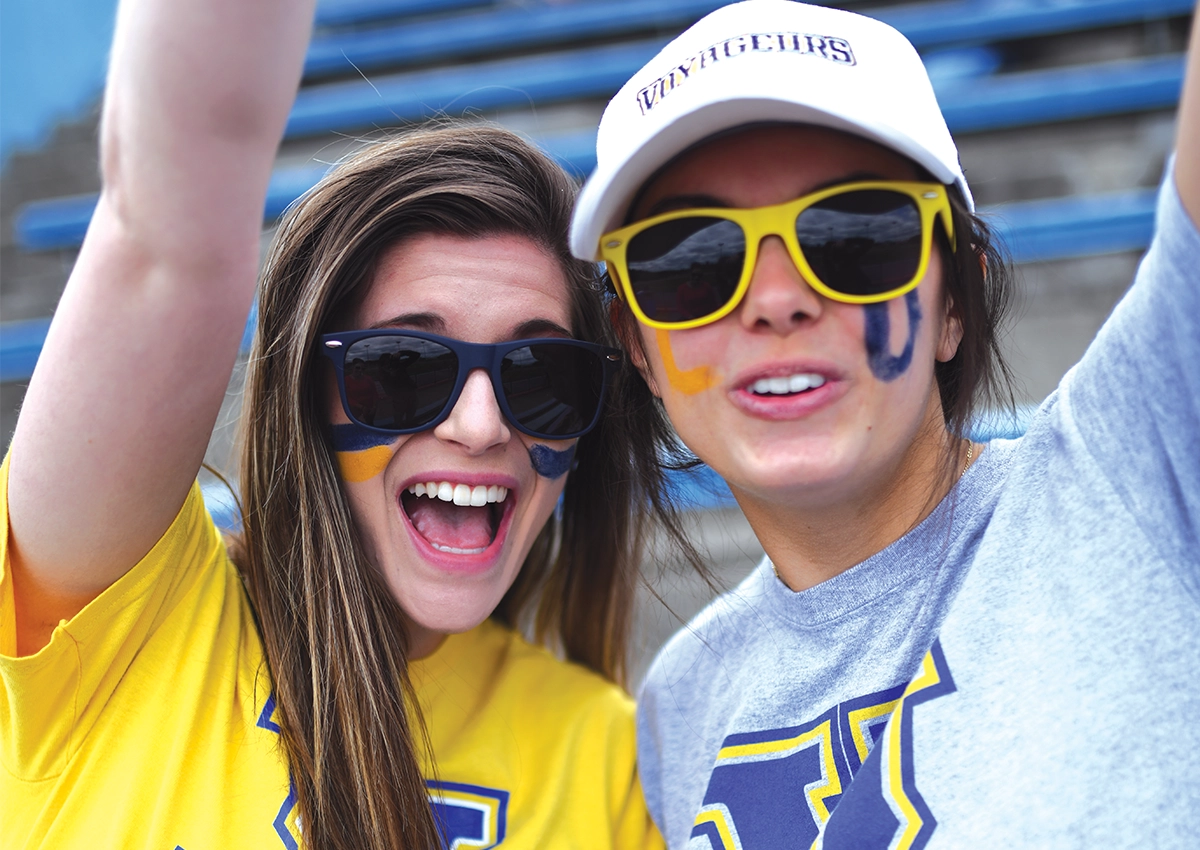 Two Laurentian University students at Orientation dressed in Laurentian gear and facepaint.