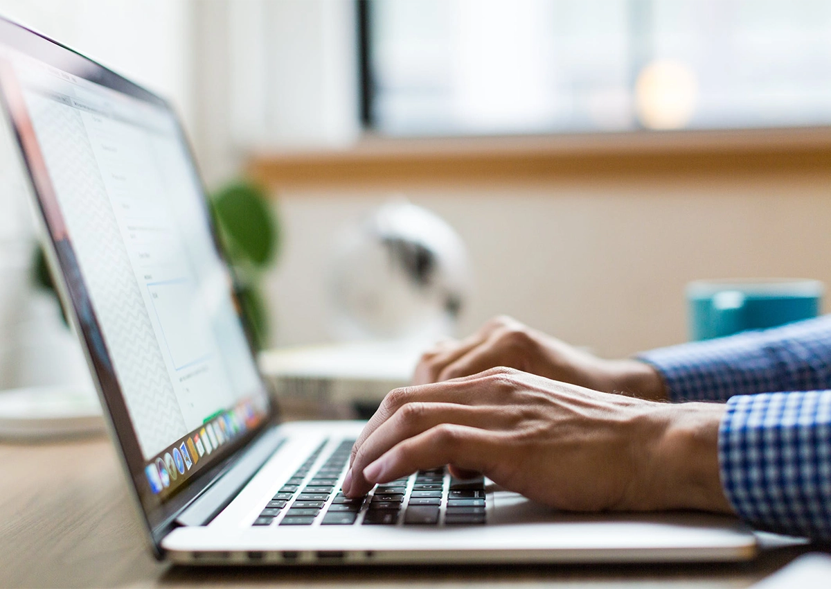 A person typing on a laptop.