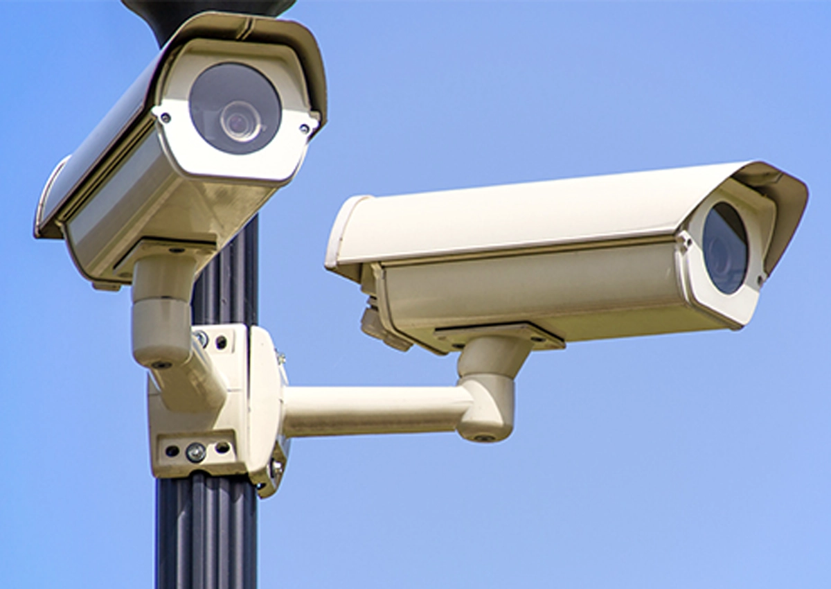 Two security cameras on a pole.