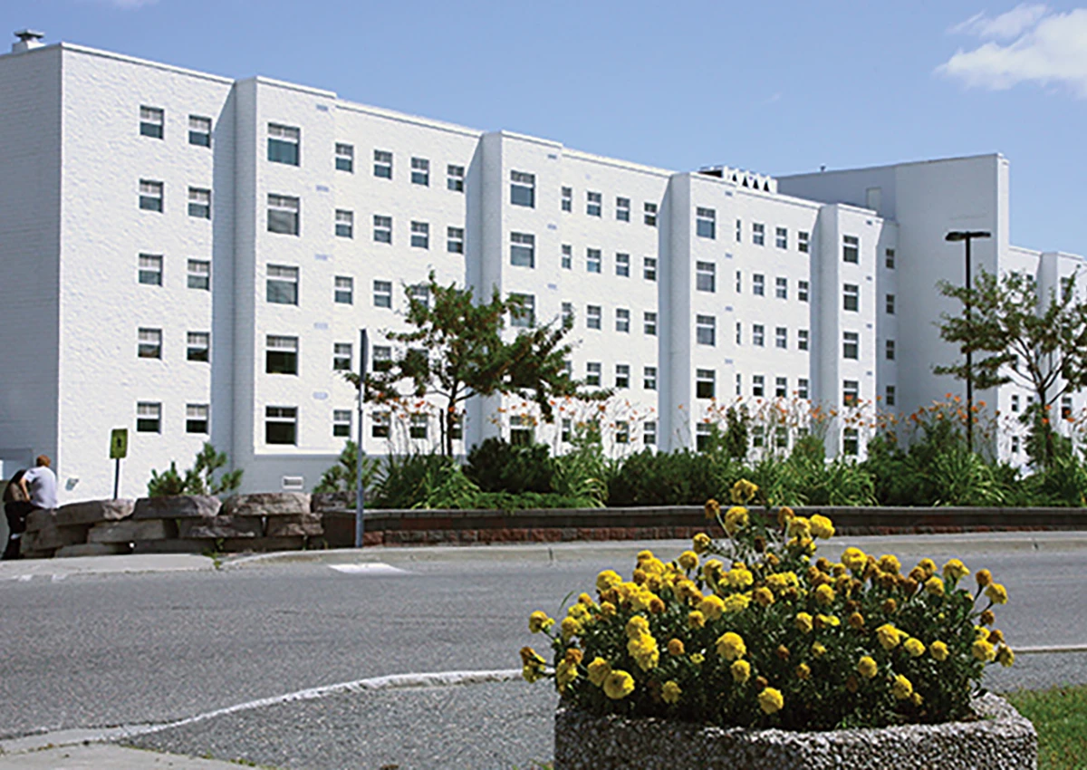 the outside of west residence on a sunny day