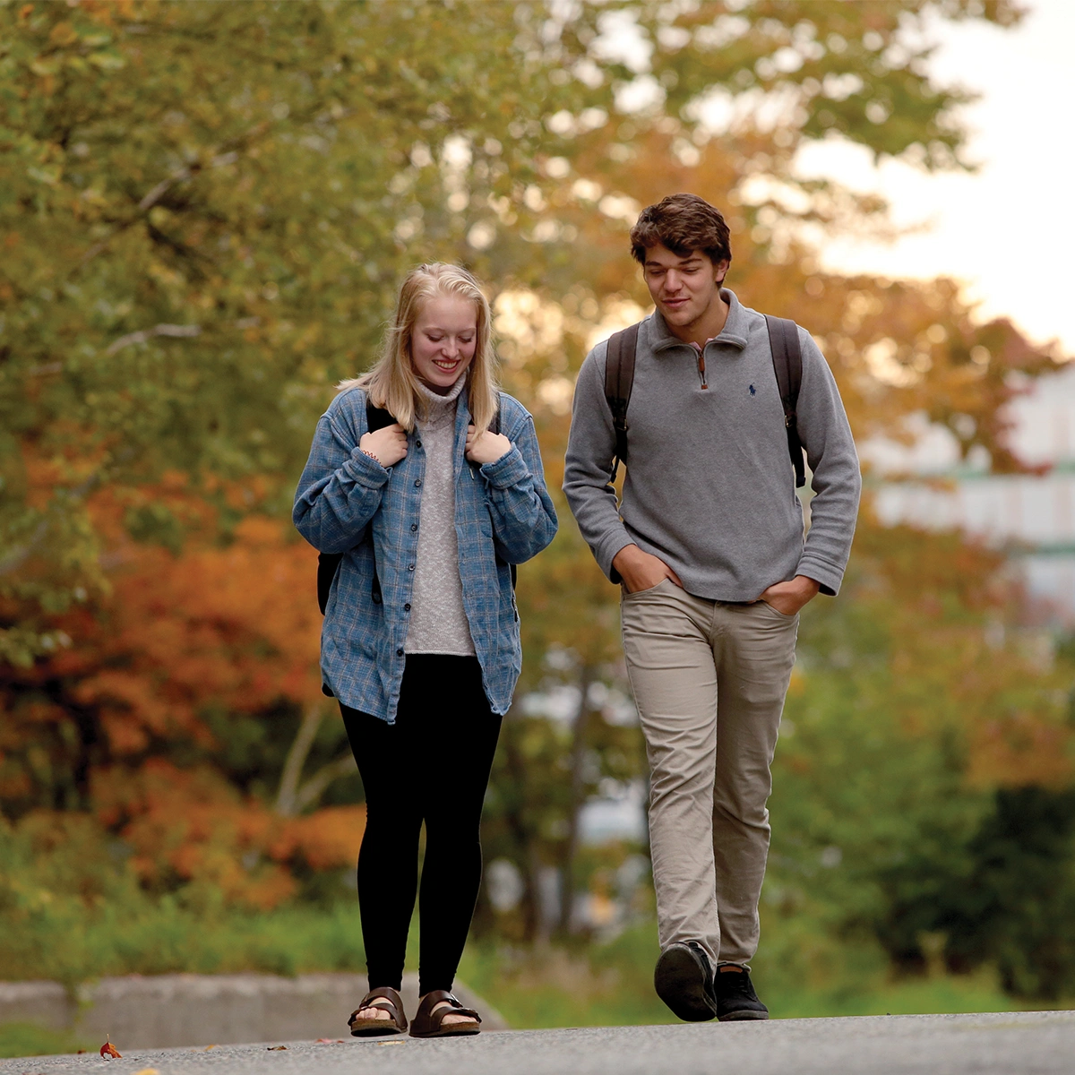 Two Laurentian University students walking on campus in the Fall.