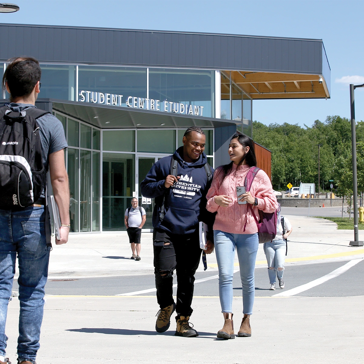 Two Laurentian University students walking on campus.