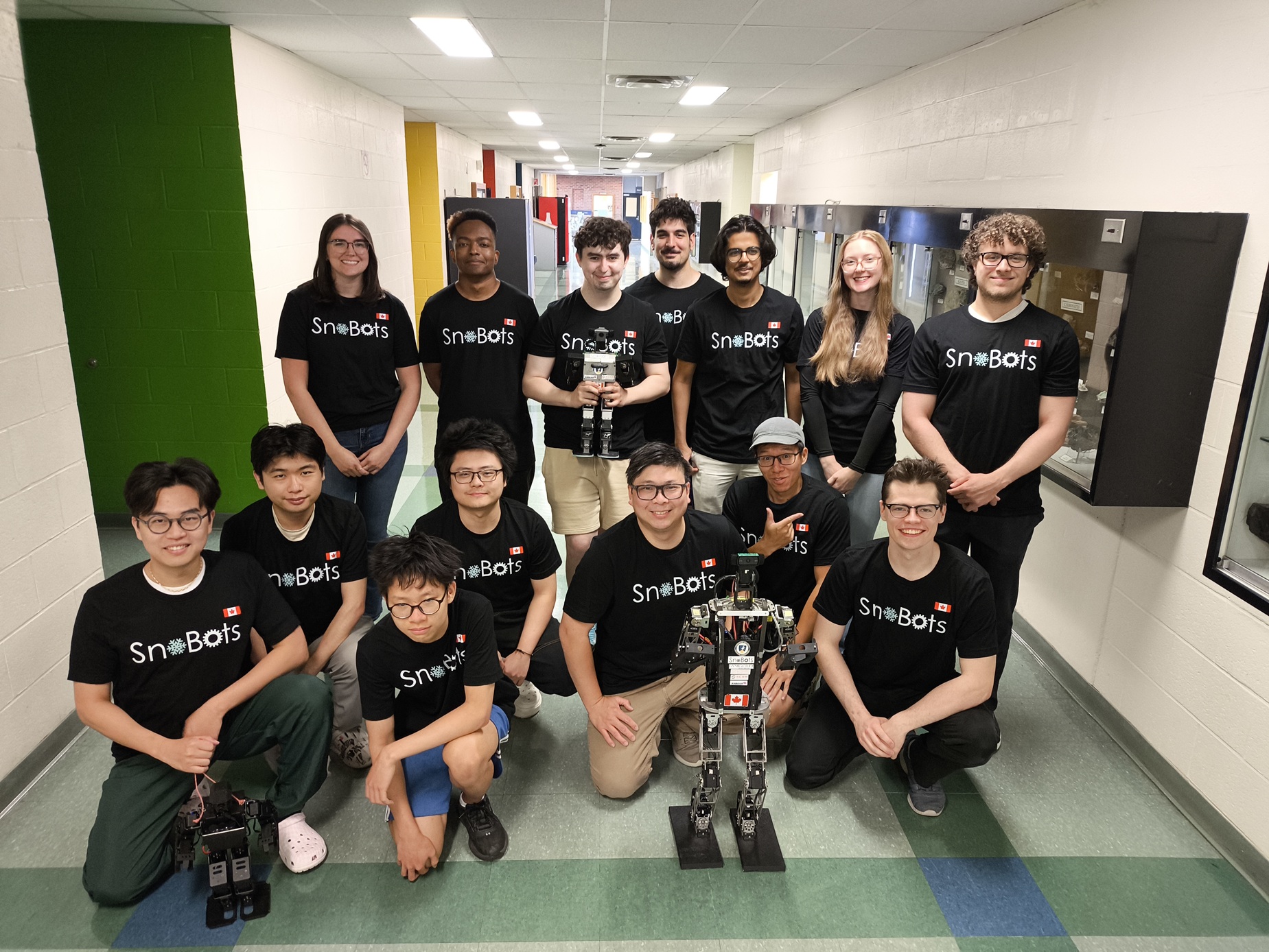 Members of the Snobots teams in their snobots shirts with their robots