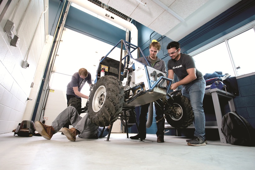 Students working on a buggy in the machine shop