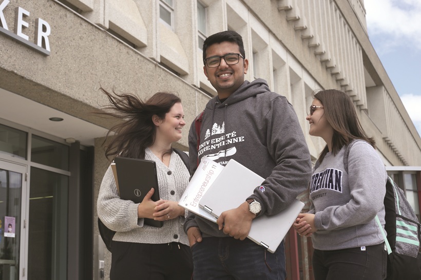 3 students outside the University