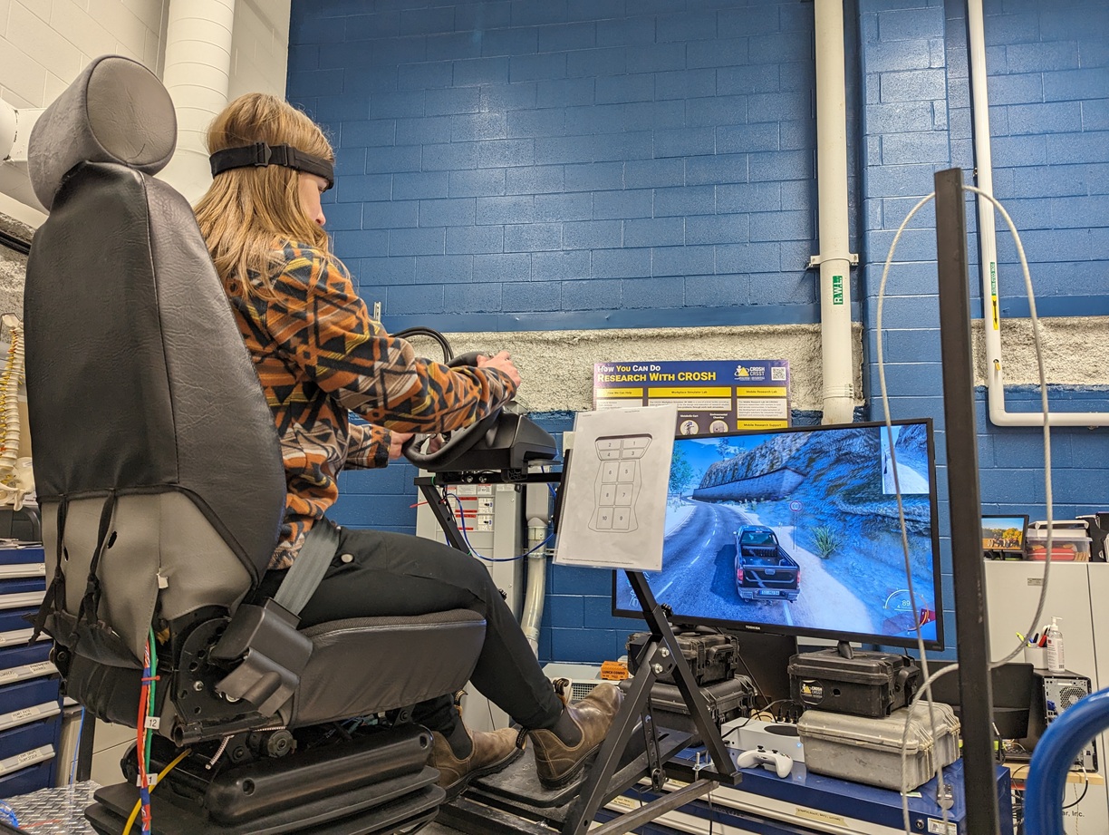 Person driving a car simulator