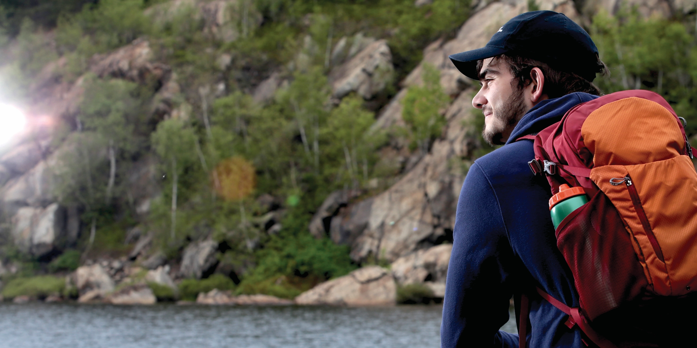 A Laurentian University student standing in front of a lake.