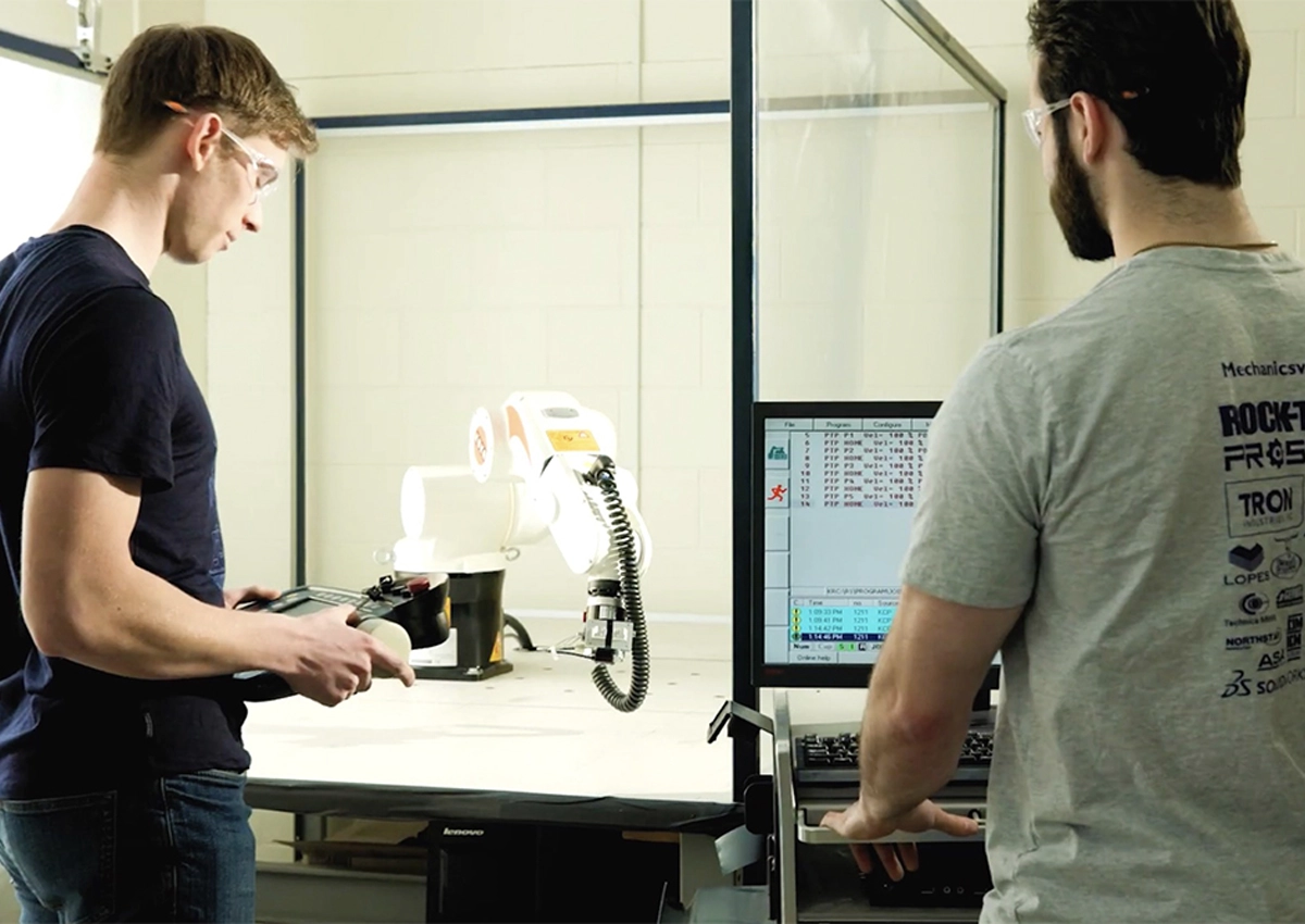 Two mechanical engineering students working on a project.