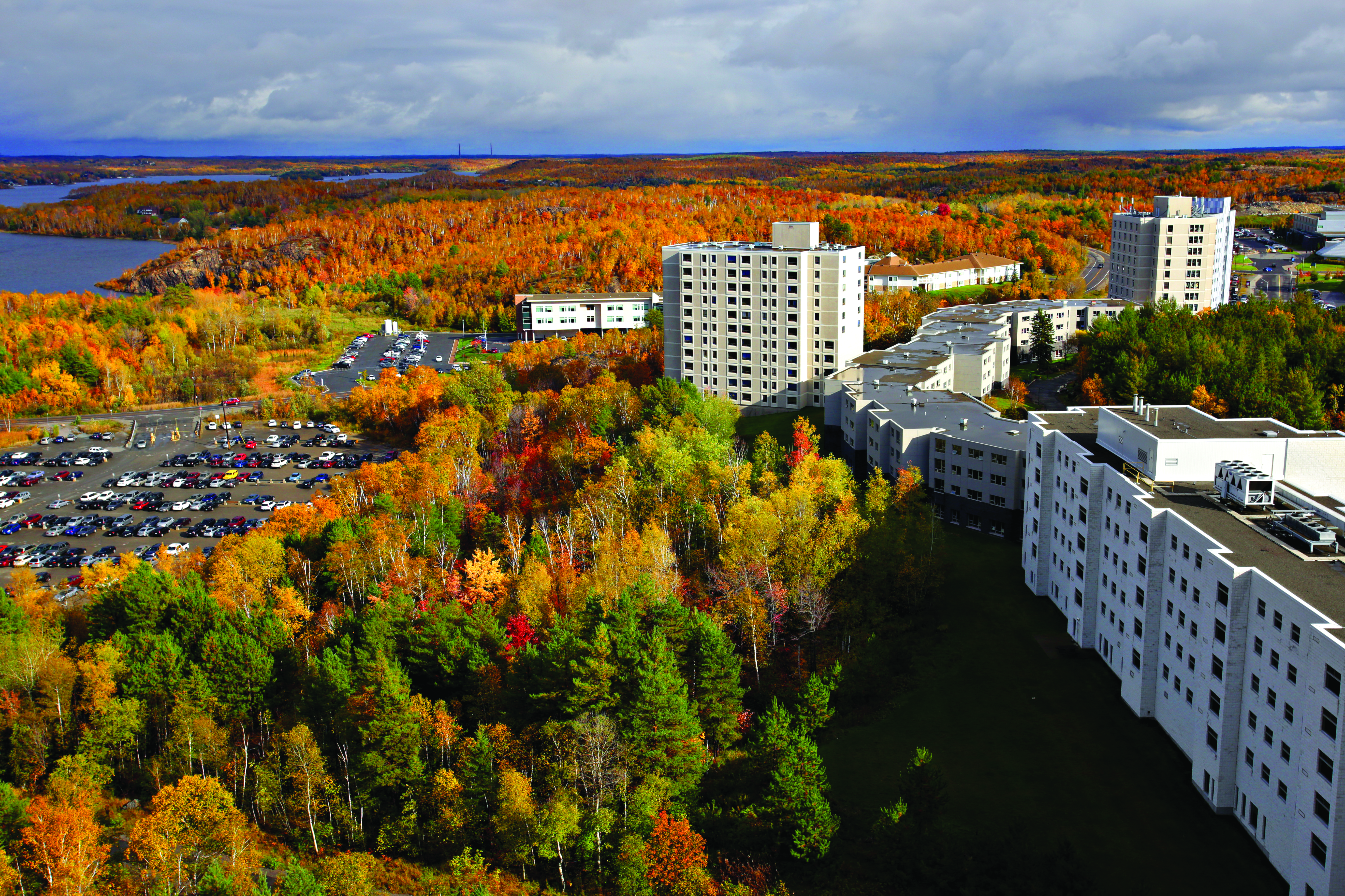 Aerial view of Laurentian University campus surrounded by vibrant autumn trees.