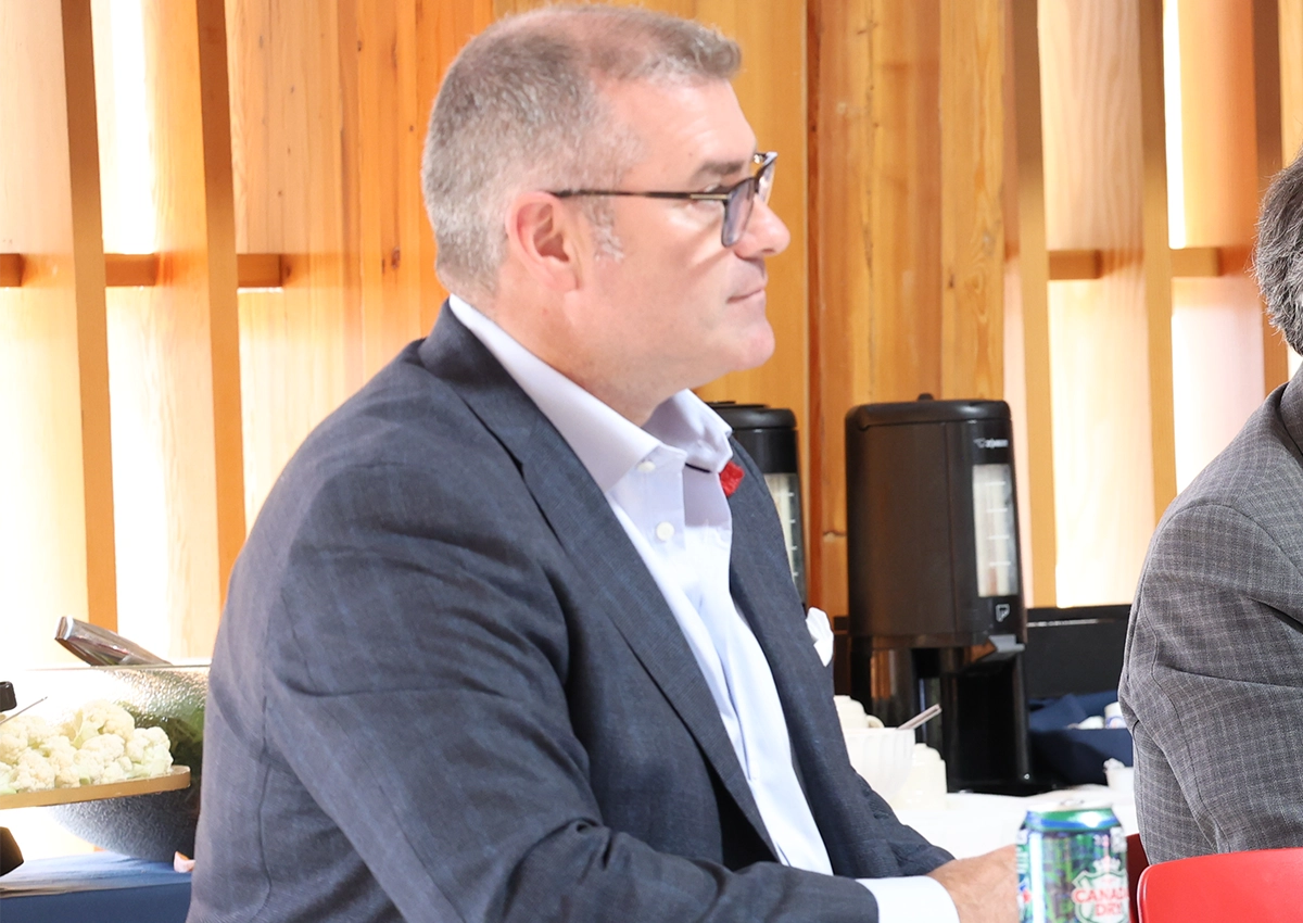 Laurentian University Chancellor Kristan Straub sitting at a desk