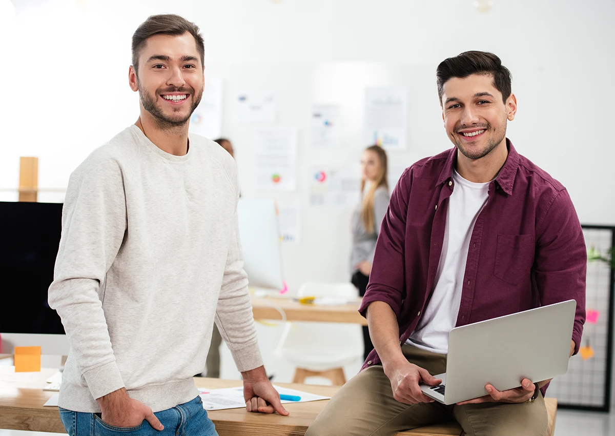 Two computer programmers smiling.