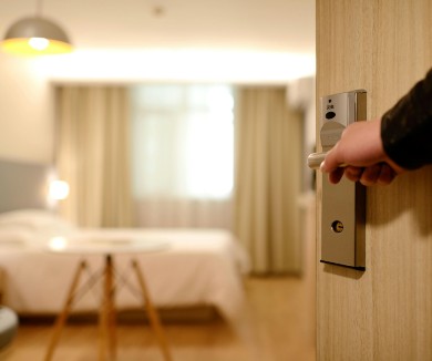 A hand opening a hotel door