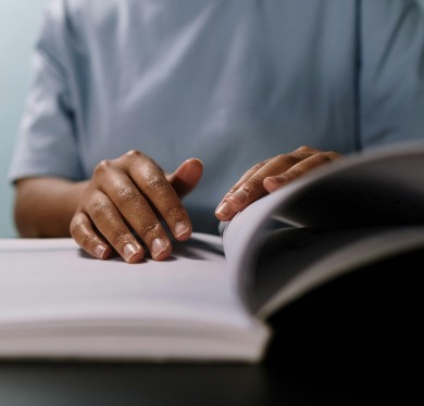A person going through a manual page by page