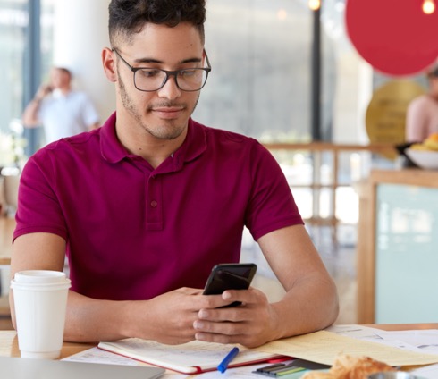 A student on their phone, smiling.