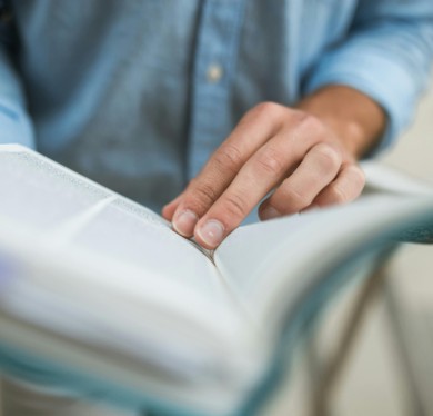 A man reading a thick book
