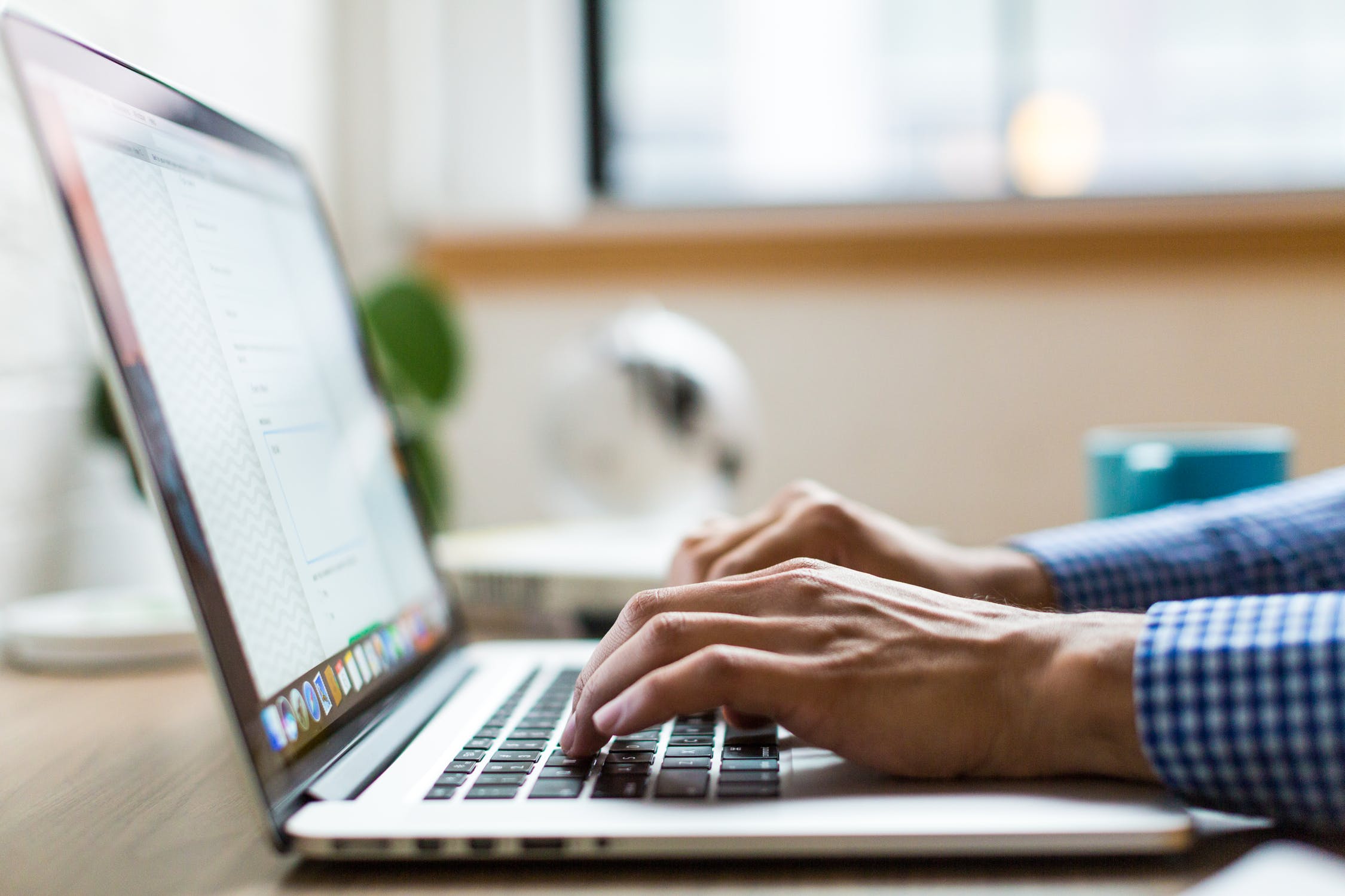 Someone typing on a laptop