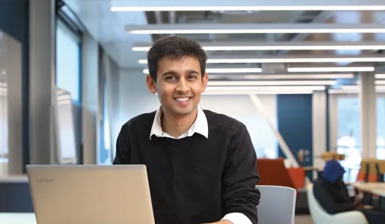 Student sitting at desk with laptop