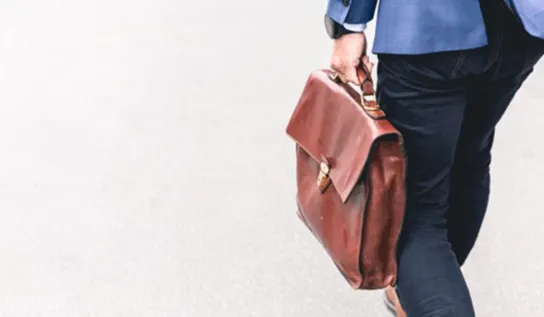 a man walks down the street in a suit