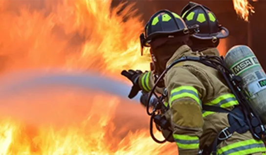 Fire fighters throwing water at a fire