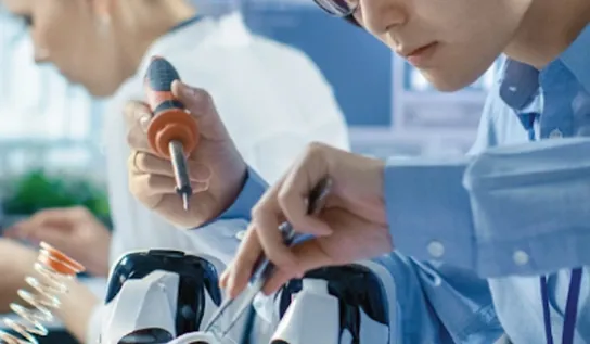 A person using tools in a lab.