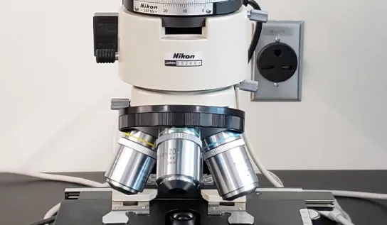 a microscope sits on a lab table