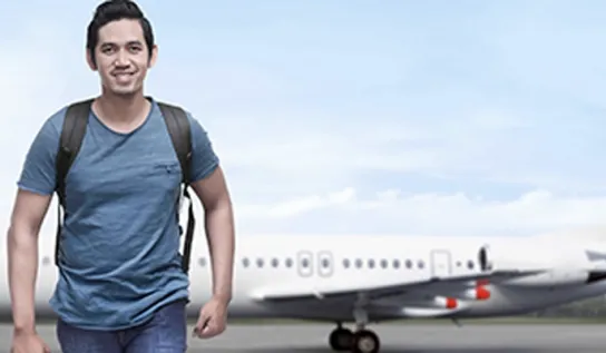 A student walking away from an airplane.