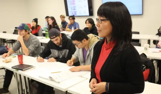 A professor standing in front of her class.