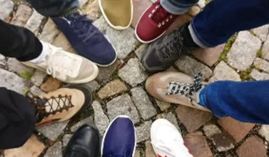 people's feet arranged in a circle
