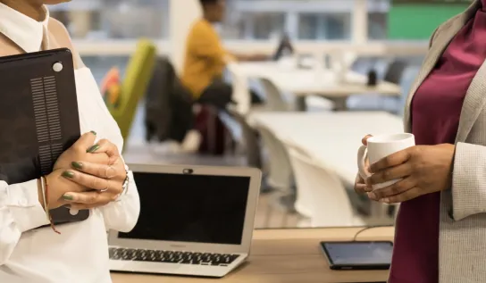 Two office workers talking to each other.