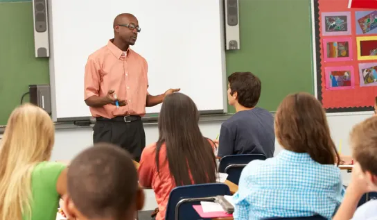 a teacher teaching a class of teenagers 