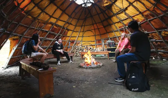 A group of Laurentian University students in a Wigwaam.